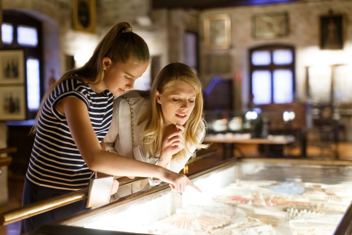 Two young women looking at museum exhibit